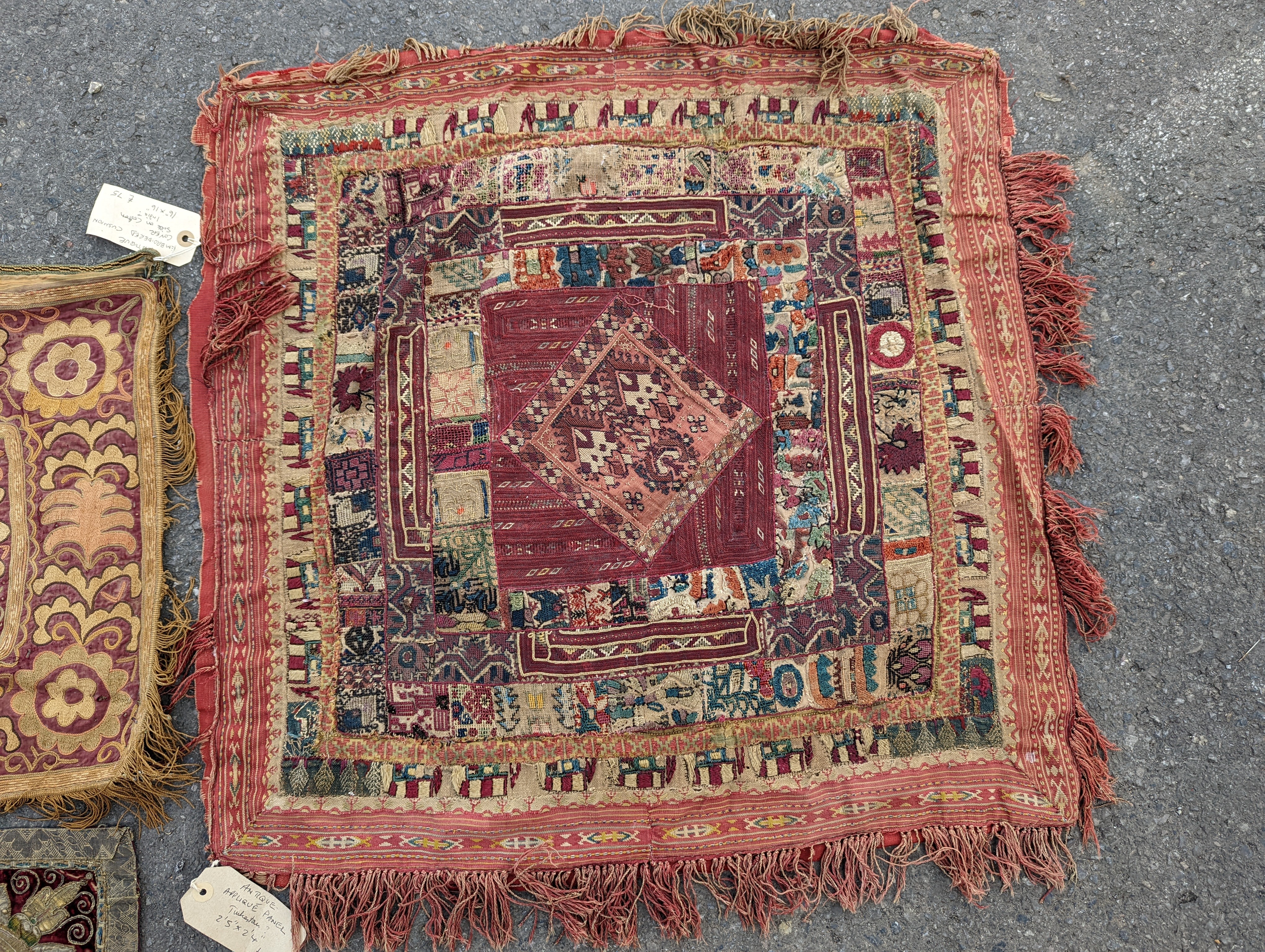 An Indian appliqué panel, two Indian appliqué covers and one other.
